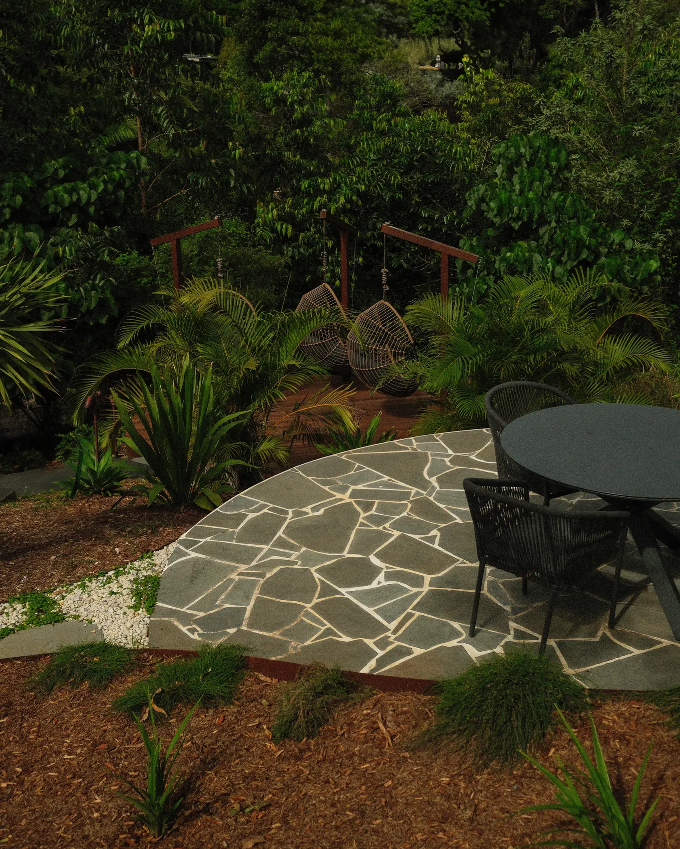 Crazy paved dining terrace under the rainforest canopy