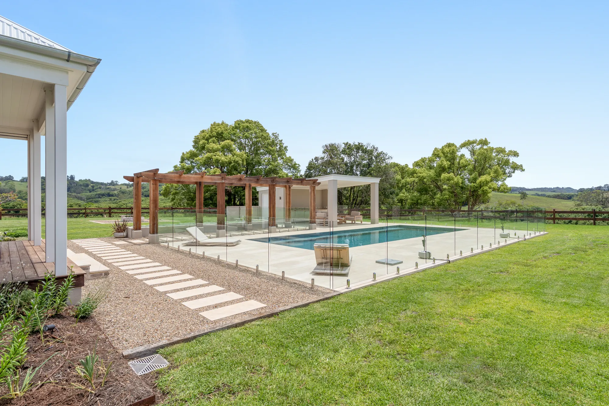 Pool, lawn and pergola across the property